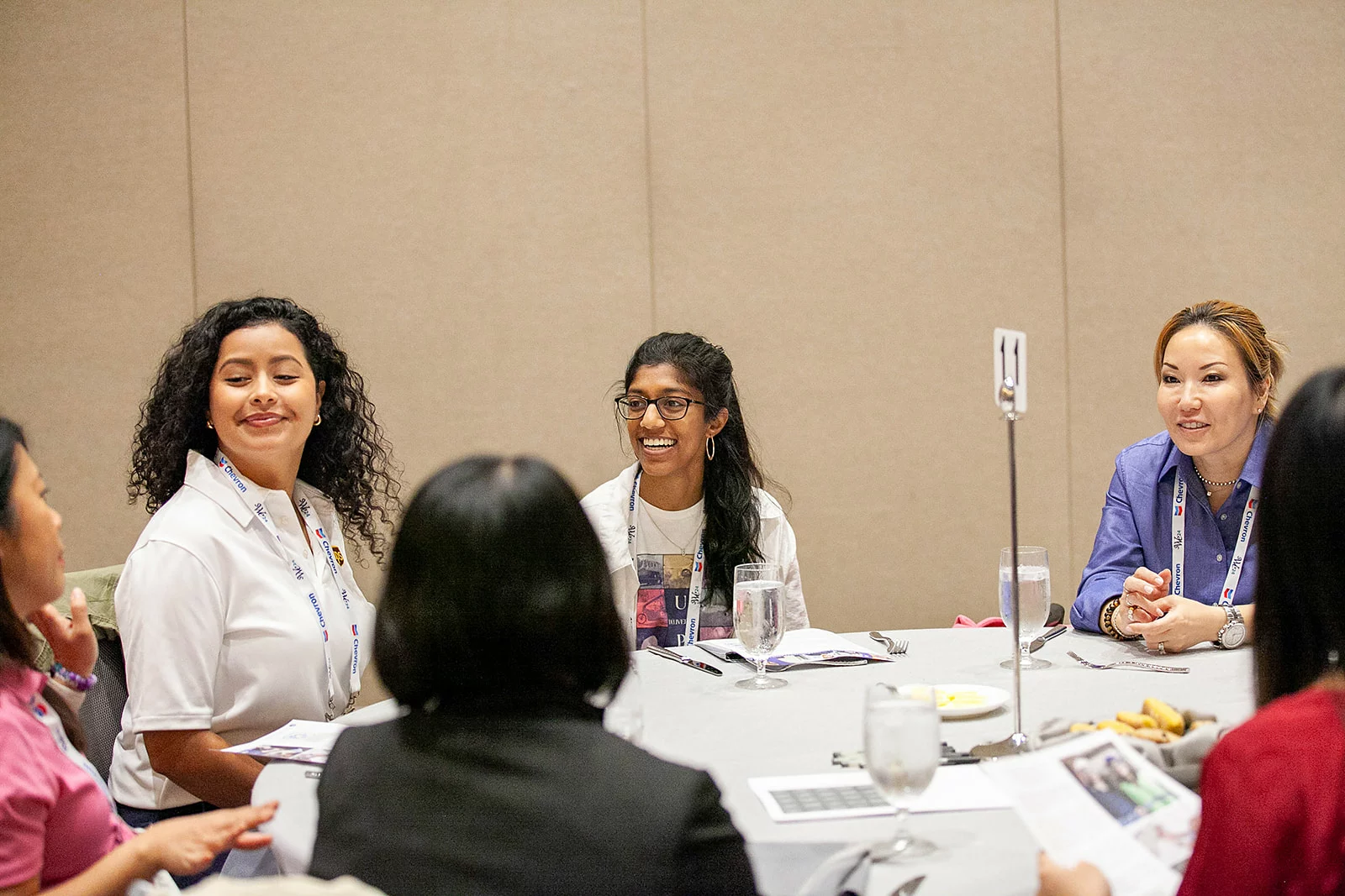 Collegiate women sitting around a table networking